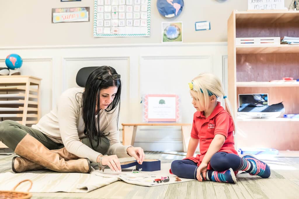 A teacher helping a child with a project